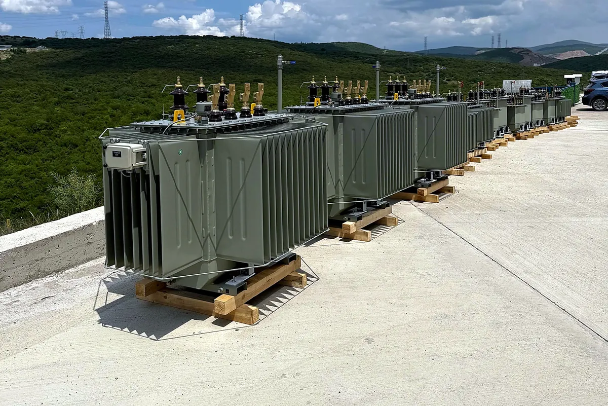 Hermetic oil-immersed distribution transformers lined up for dispatch